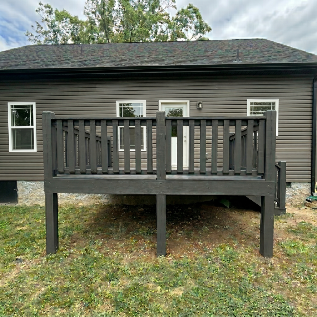 Outdoor back deck stained in a modern solid dark grey. High-quality residential deck refinishing project showcasing durable wood protection and improved curb appeal for a suburban home.